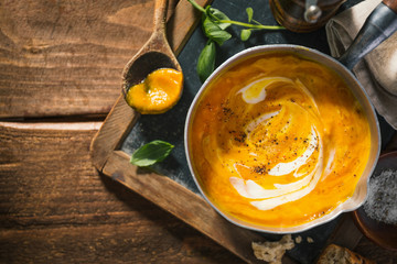 Autumn pumpkin creamy soup in pot