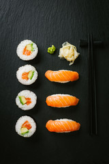 Sushi served on plate on dark table