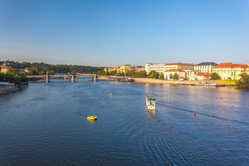 Fototapeta na wymiar View to Vitava river from Charles Bridge in Prague, beautiful summer day
