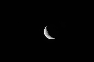 Big crescent moon in black sky