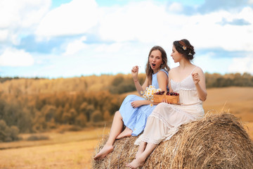 Two girls in dresses in autumn field