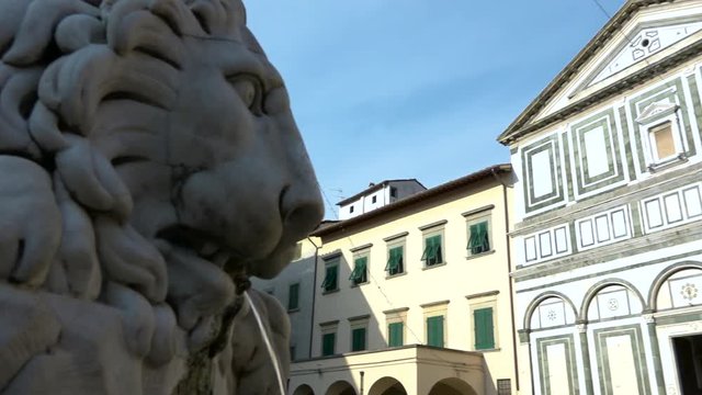 View of Collegiata Sant&rsquo;Andrea church, Empoli, Italy. Sight of main square of the city, Piazza Farinata degli Uberti, Tuscany, with lions fountain and Florentine Romanesque facade of basilica