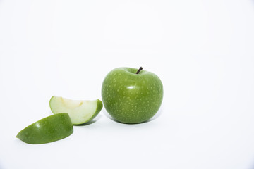 green apple and cut isolated on a white background