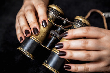 Ancient binoculars in female hands