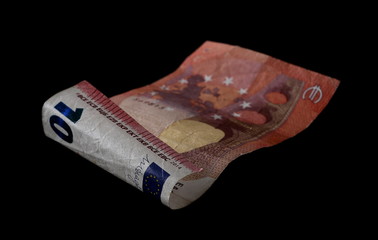Flying 10 ten euro banknote isolated on black background