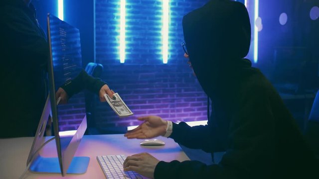 Male hacker receiving money for breach of database