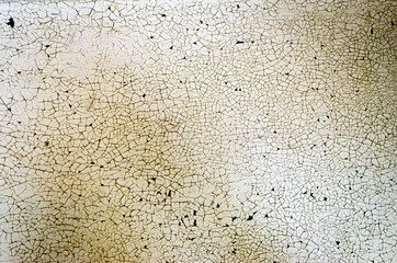 Textured background of stained cracked white painted surface