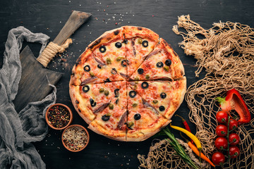 Seafood Pizza. Italian cuisine. On a wooden background. Free space for text. Top view.