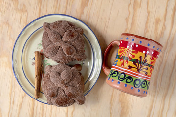 Pan de Muerto, Bread of Dead traditional Mexican sugar scone, cup and dish, baked on day of the dead festivities.
