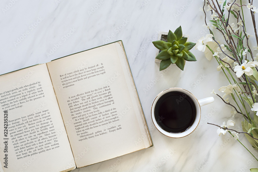 Wall mural flatly of book and coffee on table for morning relaxing time