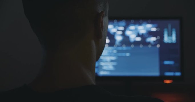 Hacker is working in dark room