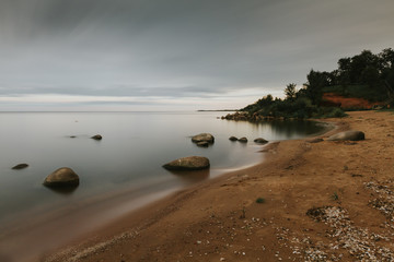 A quiet beach with round stones.