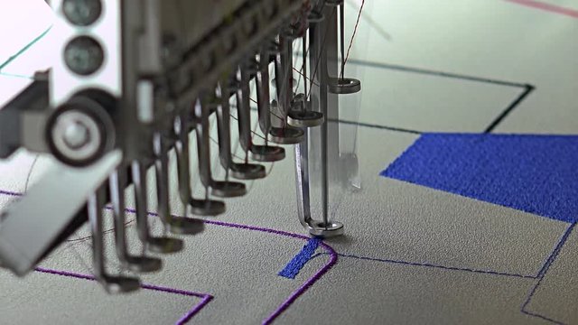 Automatic modern sewing machine embroider a pattern,Industrial embroidery equipment. Textile Manufacturers.Industrial textile factory,Textile Factory. Textile Industry.