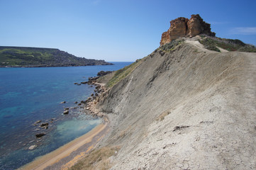 Fototapeta na wymiar Rocky cliffs of Gnejna Bay, Golden Bay, Malta