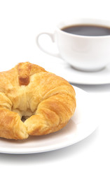 Freshly Baked Buttery French Croissants on a White Background with a Cup of Black Coffee