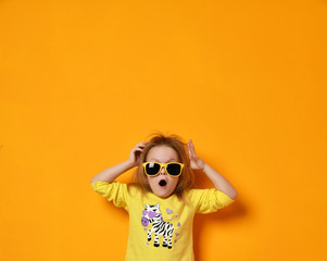 baby girl child kid surprised screaming in yellow zebra shirt and sunglasses with text space