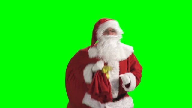 Merry Christmas. Santa Claus in a red suit waving his hand on a green screen background of  chromakey