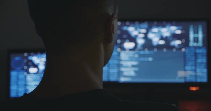 Hacker is working in dark room