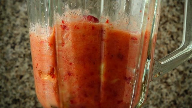 Preparation of cocktail in the blender from apples, bananas and strawberry.	Slow motion.	