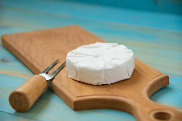 cheese camembert on blue wooden background or cheese brie