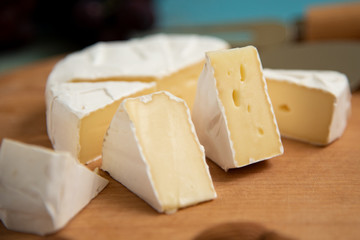 cheese camembert with raspberries and grapes on
