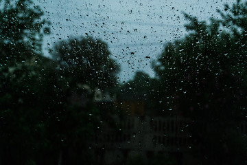 Rain drops on the window glass. Thunderstorm summer rain