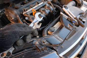Fototapeta na wymiar car repair tool in mechanic's hand 