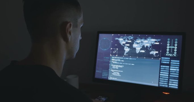 Hacker is working in dark room