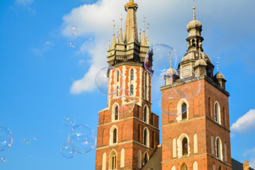 Fototapeta na wymiar Soap bubbles on the background of the St. Mary's basilica in Krakow