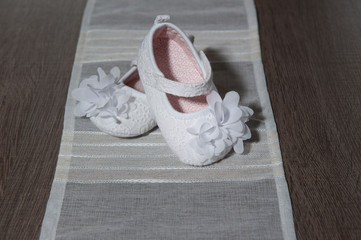 White baby's shoes for ceremony