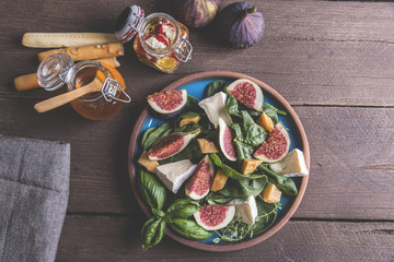 Fototapeta na wymiar salad with green, figs, cheese vegetarian dish