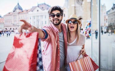 Shopping time. Young couple in shopping. Consumerism, love, dating, lifestyle concept