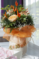 Roses and peppers into a vase