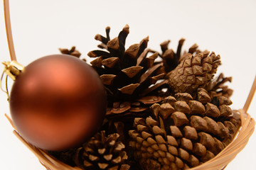 New Year's toy and bumps from a Christmas tree in a basket