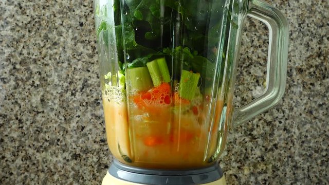 Cocktail from carrots, a stalk of a apium and spinacia.	Process of preparation of cocktail.