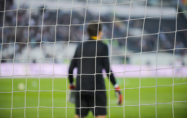 Goalkeeper behind the goal net