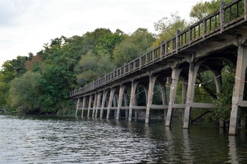 Fototapeta na wymiar Old stone bridge in the water - luna park