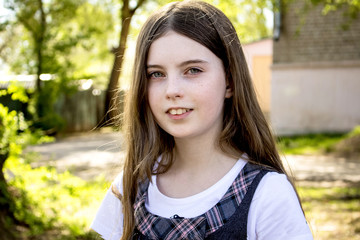 Portrait of a teenage girl, in strict clothing.  The girl in the park