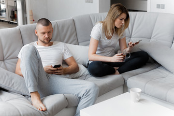 Young couple resting on sofa at home. Family relaxation lifestyle