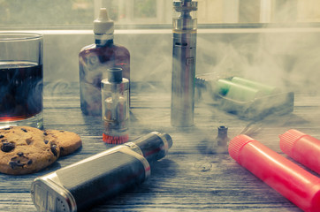 Still life with e-ciggarete and coffe on the wooden background