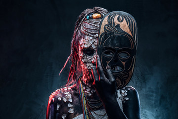 Close-up portrait of an African shaman female from the indigenous African tribe, wearing traditional costume. Make-up concept.