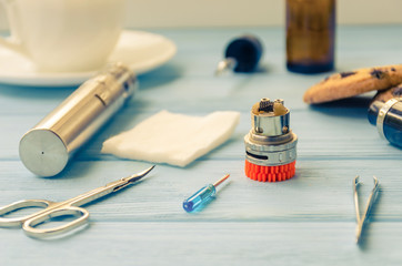 Still life with e-ciggarete and coffe on the wooden background
