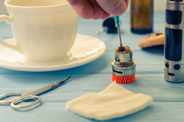 Still life with e-ciggarete and coffe on the wooden background