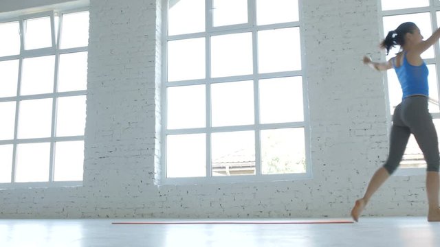 The Athletic Girl Makes a Somersault Ahead, Touching At White Fitness Class