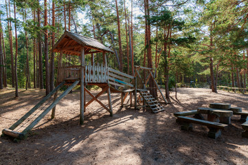 Fototapeta na wymiar Children play area in pine tree park near Saulkrasti town, Latvia