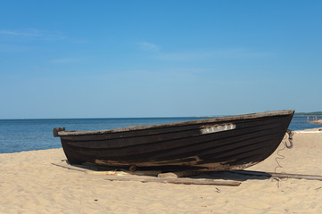 Old wooden boat at coast of Baltic sea in Latvia