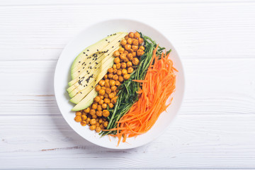 Buddha bowl with avocado , cucumber , carrot and chickpea