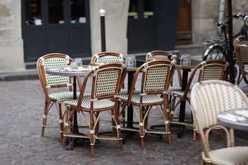 Fototapeta na wymiar Empty chairs in a parisian cafe in Montmartre