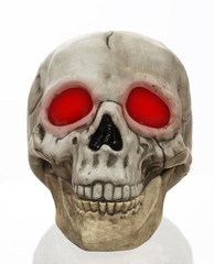 Model Skull with Red Glowing Eyes on White Background