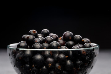 Photo of black currant in glass transparent cup
